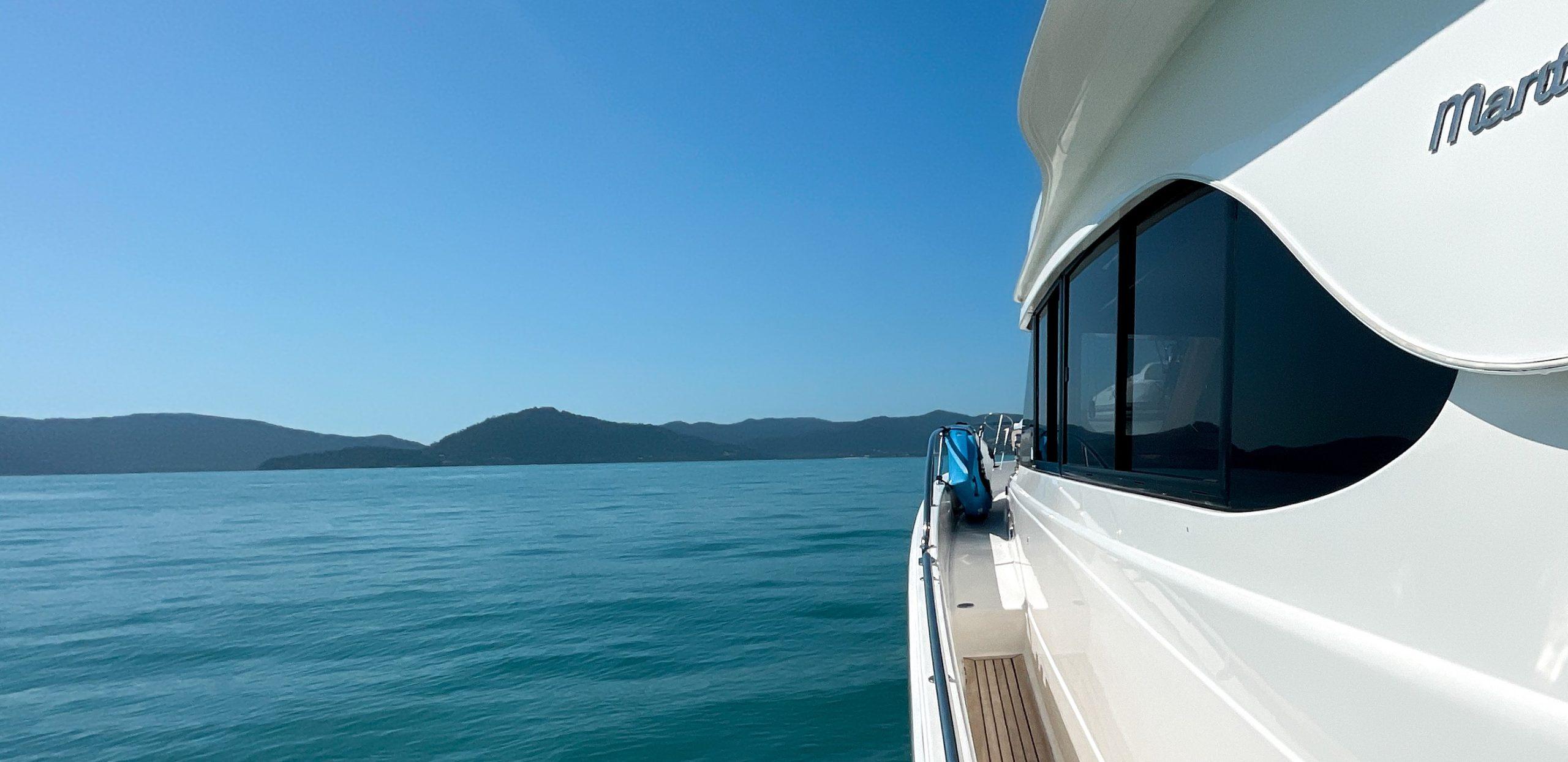 A luxury motor yacht under way on a bright Whitsundays day
