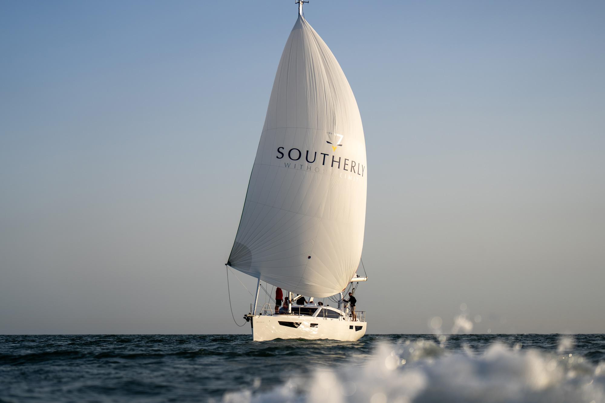 Southerly under her branded spinnaker at sunset