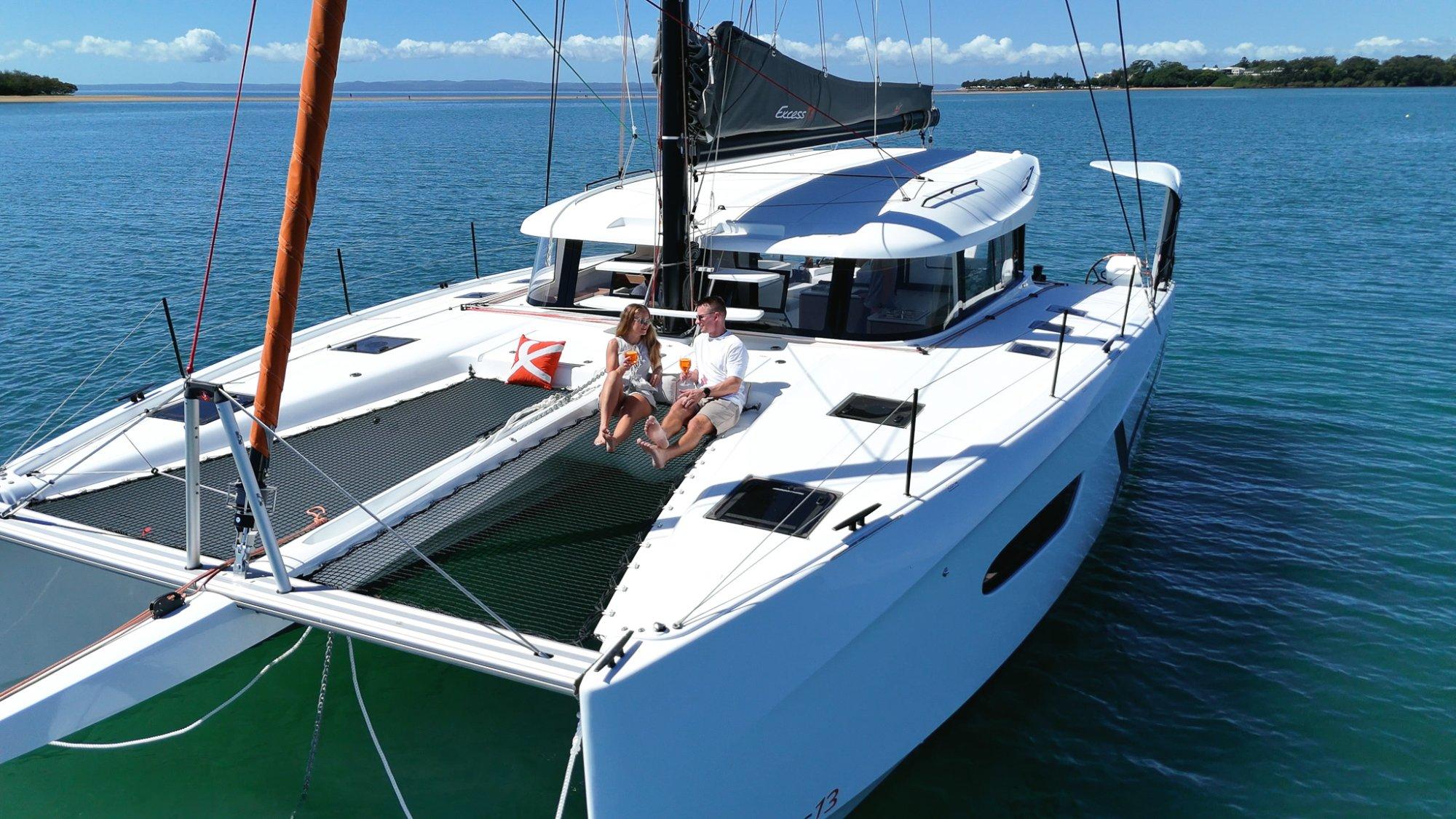 An Excess 13 catamaran at anchor in clear Australian water